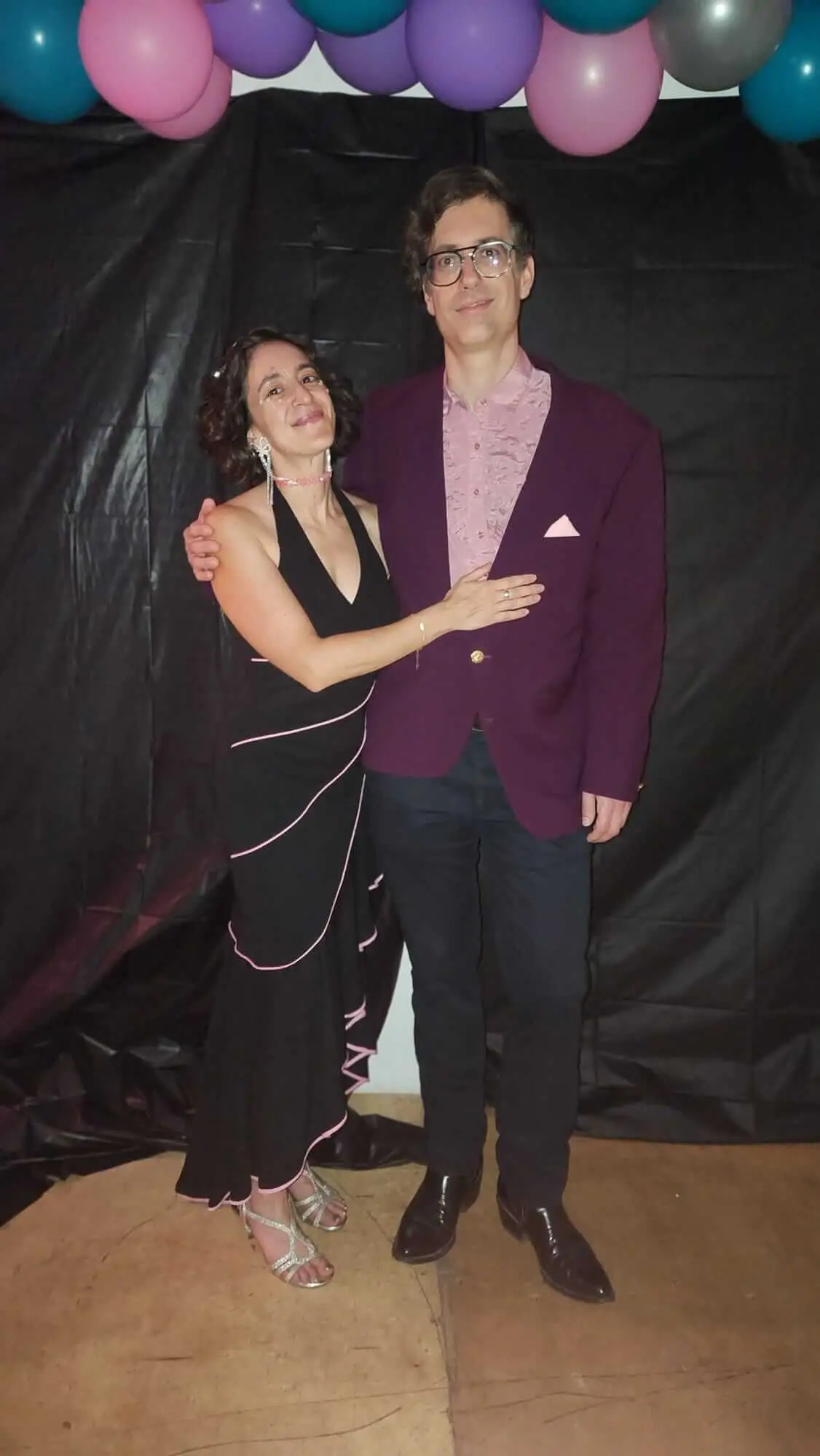 Two Dancewave guests pose together beneath a balloon arch