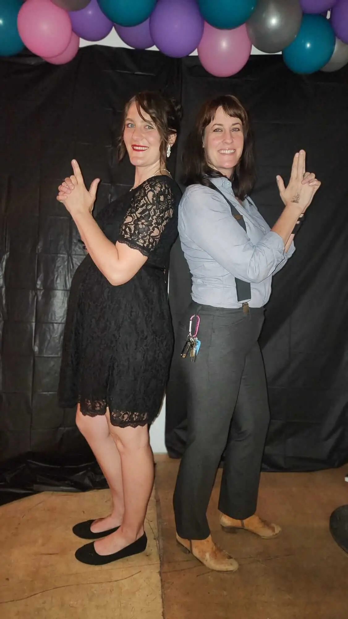 Two Dancewave guests strike matching poses at the photo booth